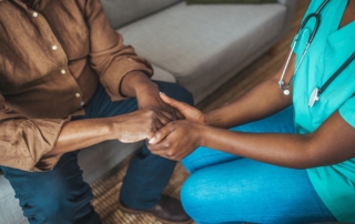 Cropped shot of a female nurse hold her senior patient's hand.