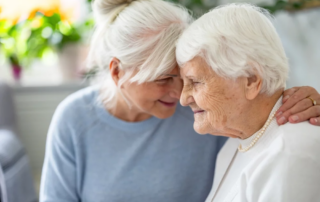 Happy senior woman with her adult daughter at home